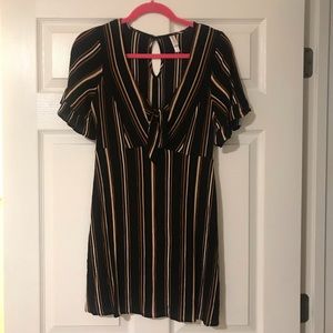 Short black dress. Ruffles on the sleeves.